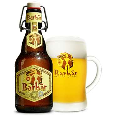 Barbãr blond honingbier met schuimkraag in Barbãrglas met beugelfles ernaast